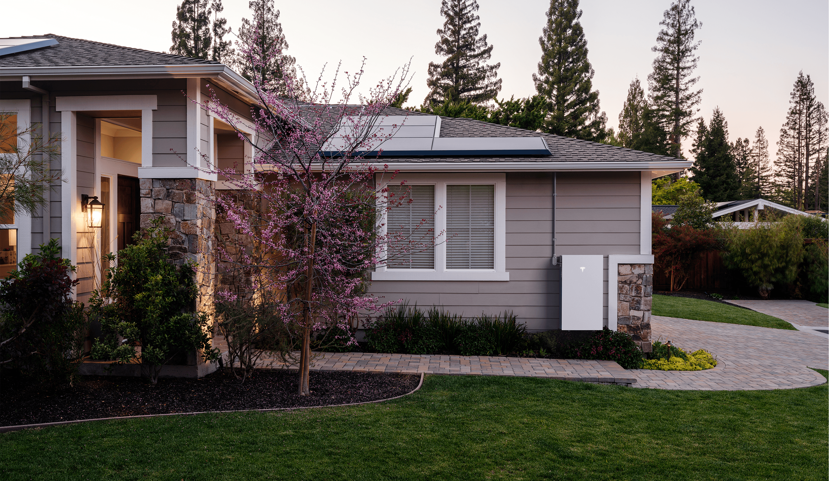 House with solar panels and an exterior battery backup system.